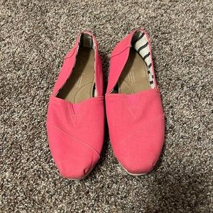 Two pairs of Toms slid ons. Both size 7 one pair is pink one pair is black